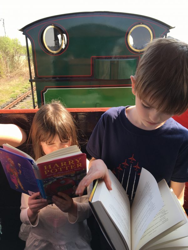 Alex and Emily reading on a train