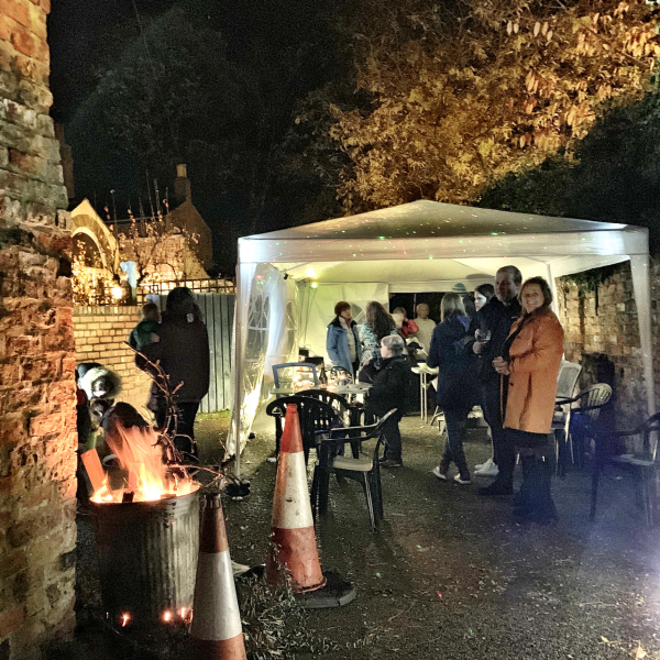 Back Street Party with glowing brazier, gazebo and neighbours.