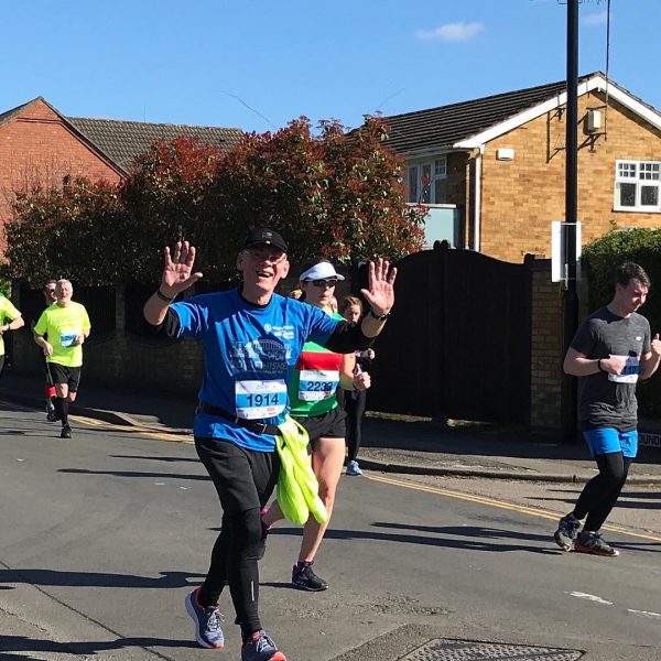 Barrie running the Coventry Half Marathon - arms raised aloft.