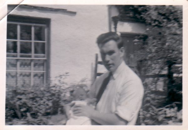 Baby Barrie and his father, Deb, outside Rose Cottage in Elterwater