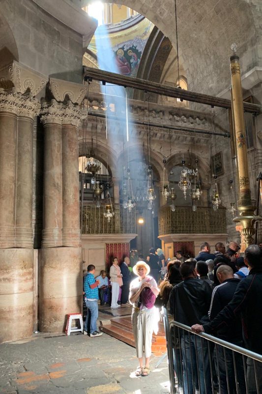 Joan in a shaft of light inside the church of the Holy Sepulchre 